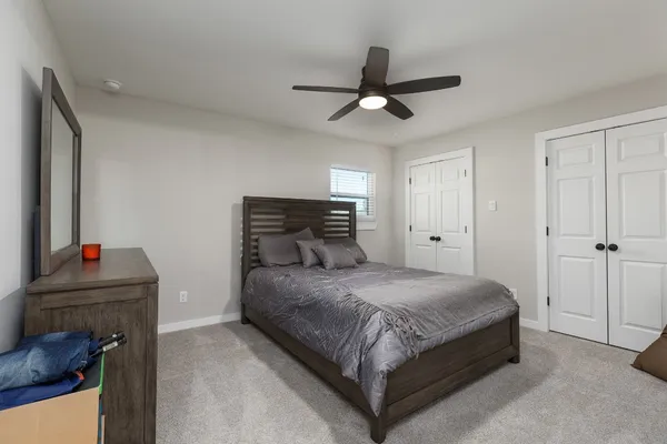 a bedroom with a bed and a chandelier
