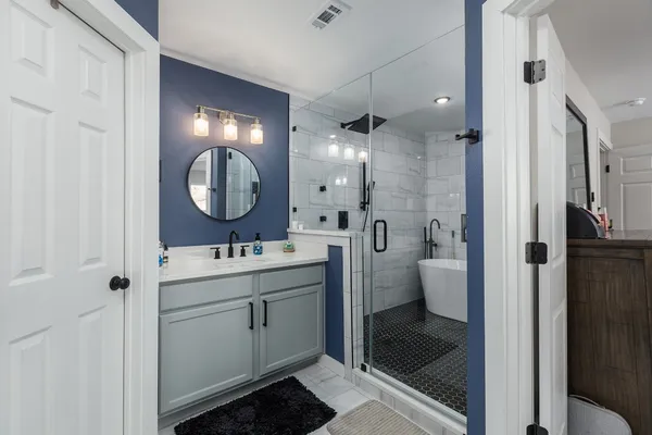 a bathroom with a bathtub and shower