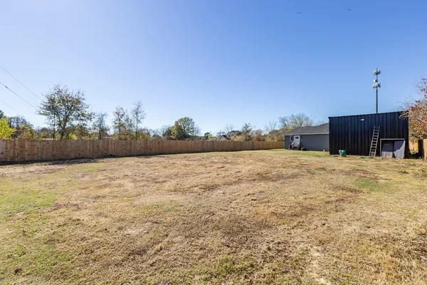 a view of a house with backyard and garage