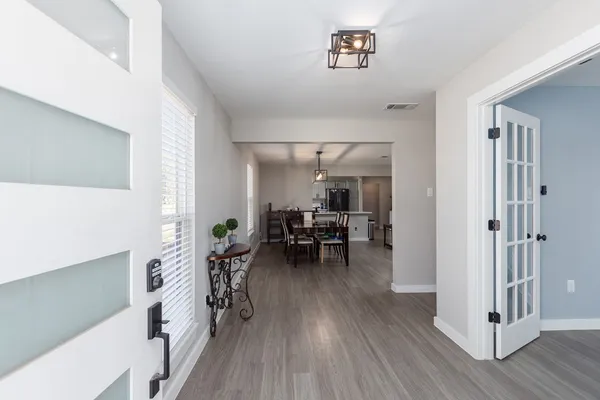 a living room with furniture and wooden floor