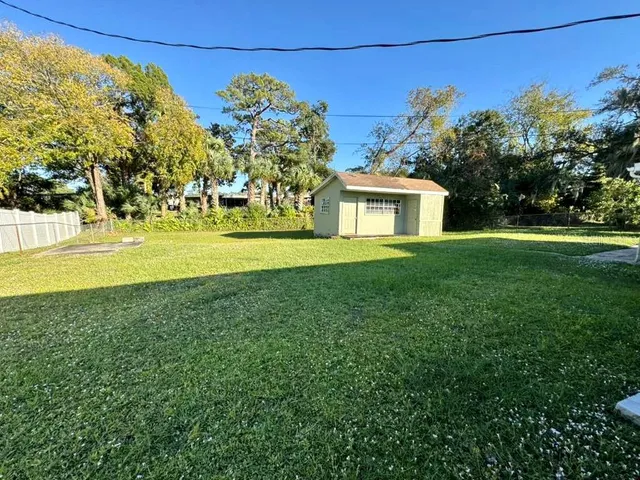 a front view of a house with a yard and a big yard