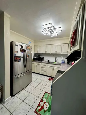 a kitchen with stainless steel appliances a sink a refrigerator and a stove top oven