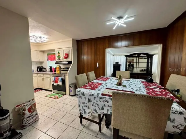 a dining room with furniture and chandelier