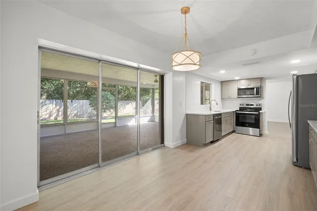 a view of a kitchen with a sink and stainless steel appliances