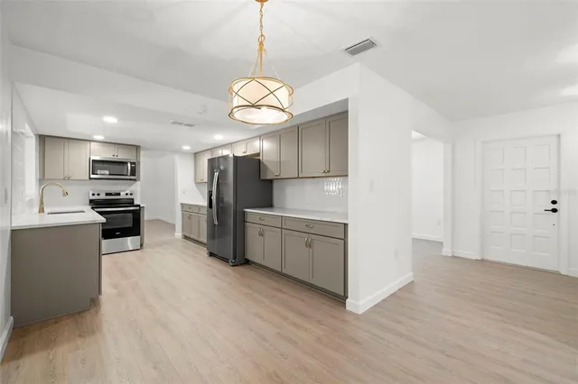 a kitchen with a refrigerator a microwave and a stove