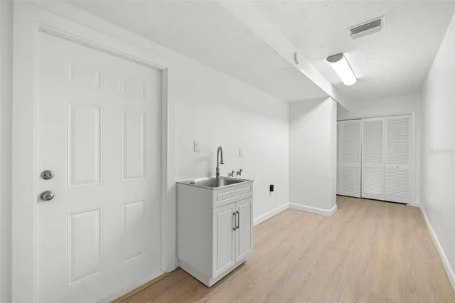 a view of a kitchen with white cabinets