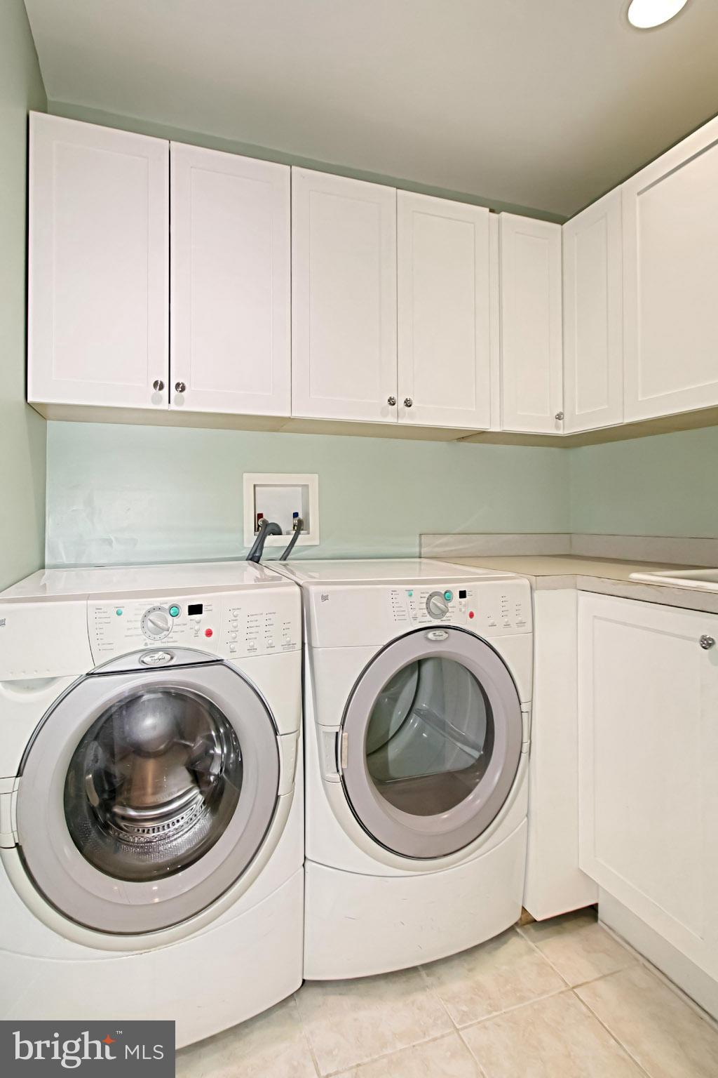 435 Utterback Store Road Great Falls, VA 22066 - Photo 14 of 30 First floor laundry room with cabinets & sink