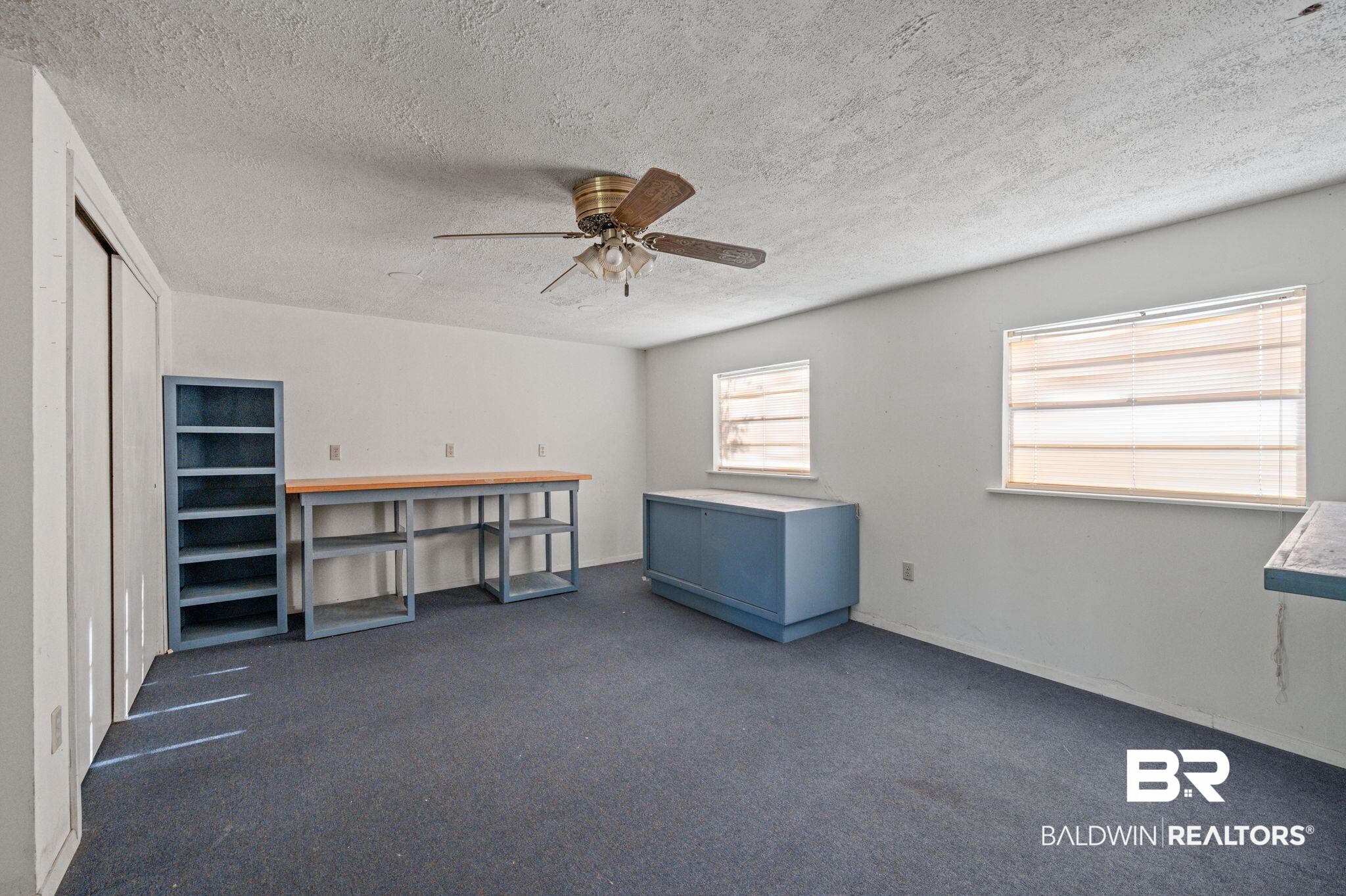 909 Caroline Avenue Daphne, AL 36526 - Photo 36 of 46 Miscellaneous room featuring ceiling fan and a textured ceiling