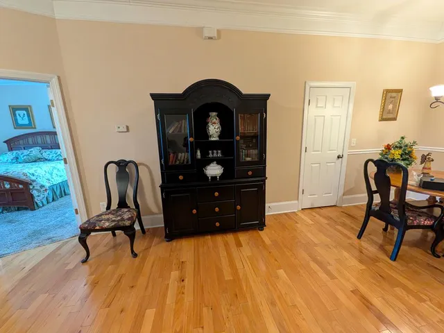 a view of a workspace with furniture and wooden floor