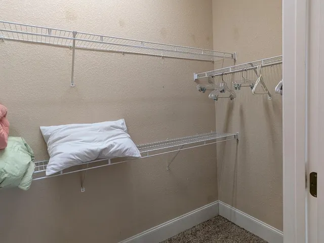 a view of a closet in the bathroom