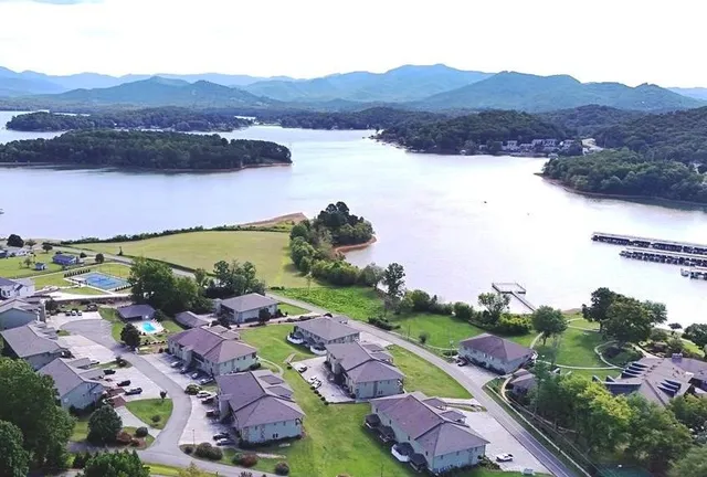 an aerial view of lake residential house and mountain view