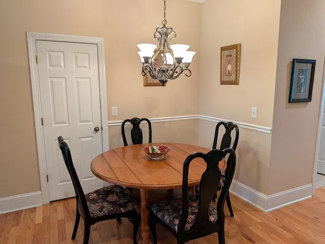 a view of a dining room with furniture and chandelier