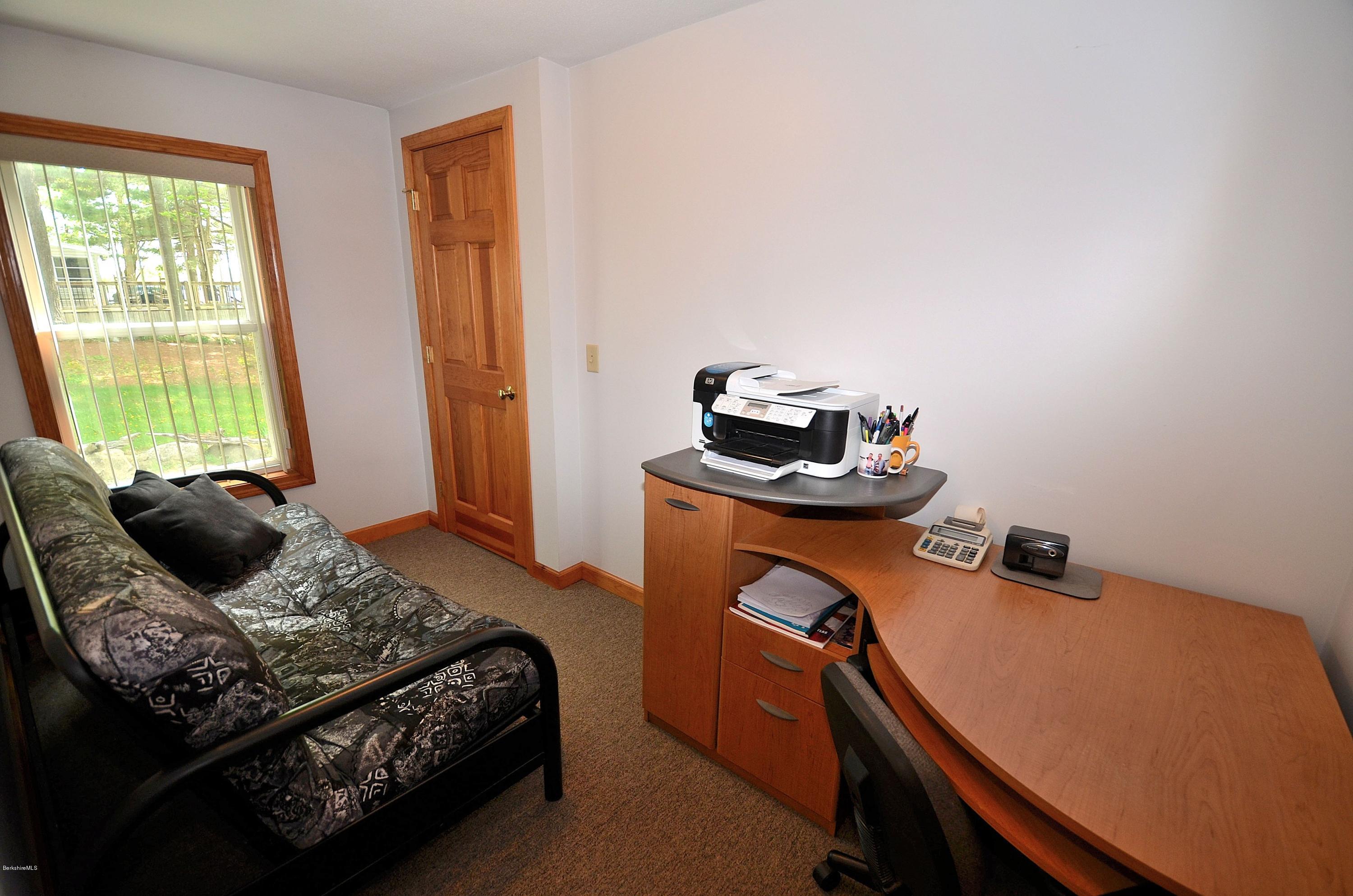 28 Ona Road Tolland, MA 01034 - Photo 14 of 31 a bedroom with a bed and wooden floor