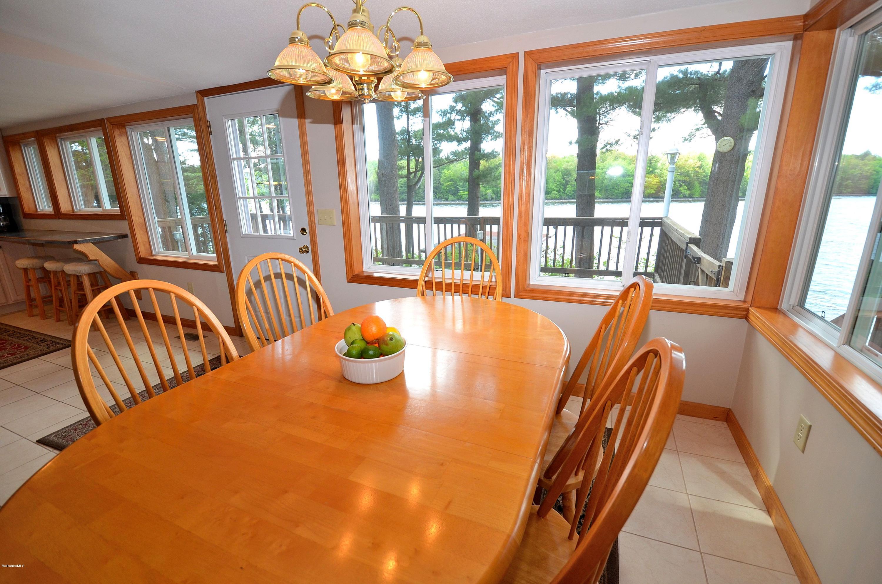 28 Ona Road Tolland, MA 01034 - Photo 7 of 31 a view of a dining room with furniture a chandelier and a large window