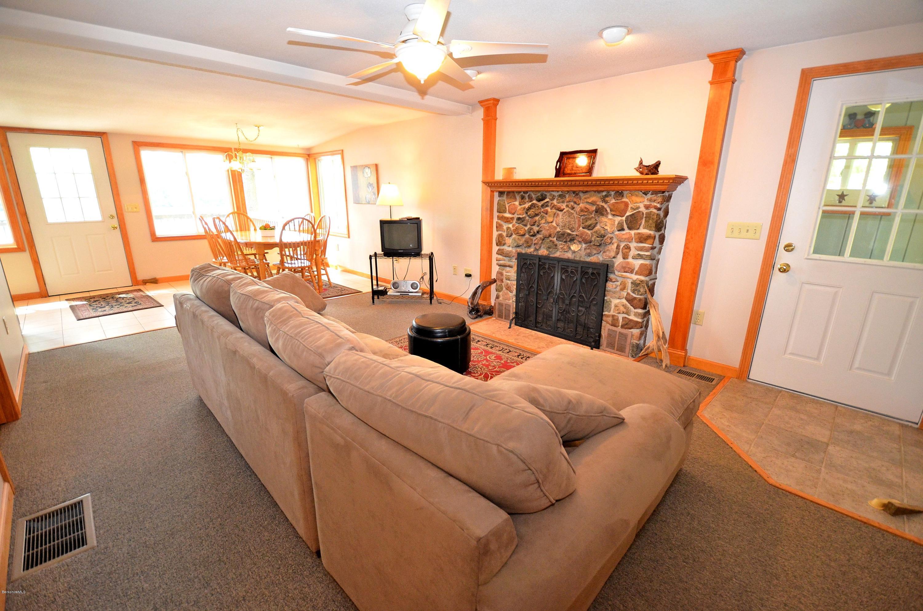 28 Ona Road Tolland, MA 01034 - Photo 9 of 31 a living room with furniture a fireplace and a large window