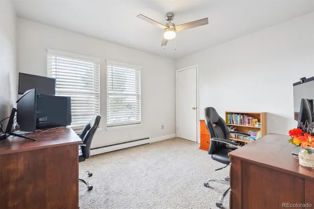 a view of a workspace with furniture and a window