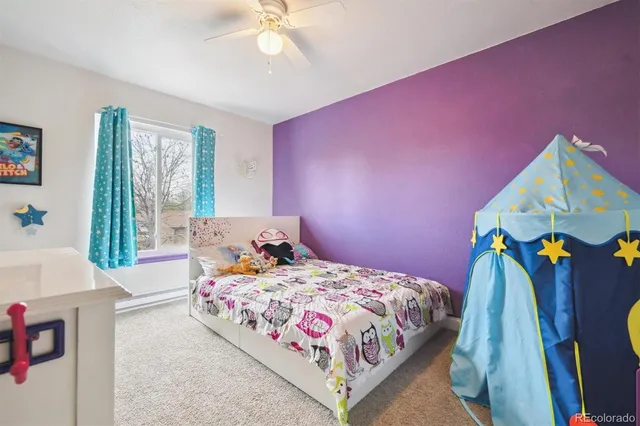 a bedroom with pink walls and bed