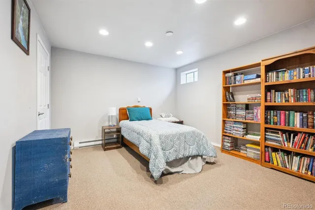 a bedroom with a bed and a book shelf