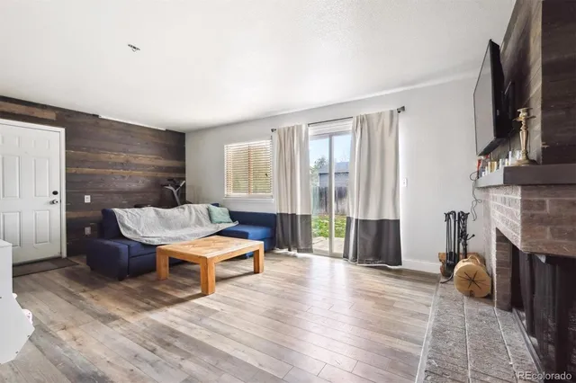 a living room with furniture a fireplace and a flat screen tv