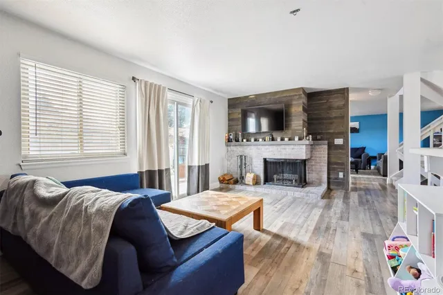 a living room with furniture fireplace and flat screen tv