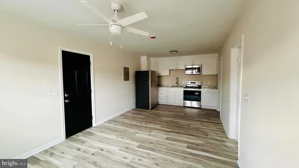 a view of a kitchen with a sink and a refrigerator