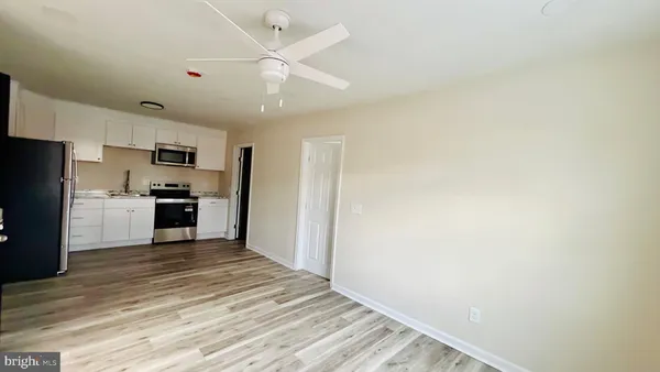 a kitchen with granite countertop a refrigerator and a sink