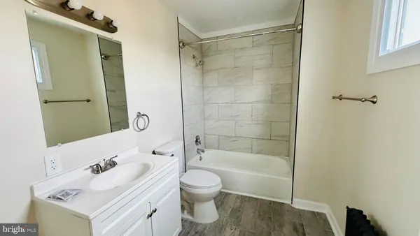 a bathroom with a sink mirror toilet and bathtub