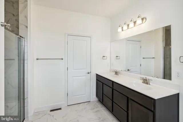 a bathroom with a double vanity sink mirror and
