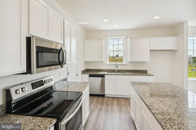 a kitchen with a stove and a microwave