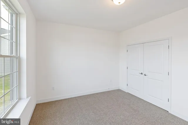 a view of an empty room and a window