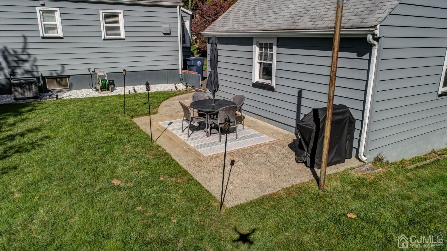 48 Coldevin Road Clark, NJ 07066 - Photo 36 of 38 a backyard of a house with table and chairs