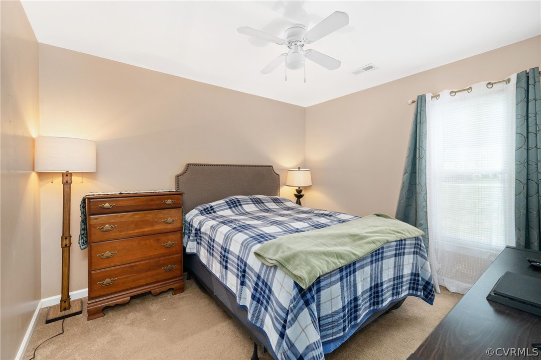 3130 Gregwood Road Midlothian, VA 23112 - Photo 27 of 39 a bedroom with a bed and a chandelier
