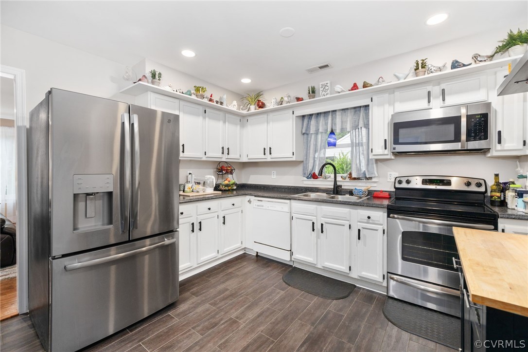 3130 Gregwood Road Midlothian, VA 23112 - Photo 3 of 39 a kitchen with stainless steel appliances a refrigerator sink and microwave