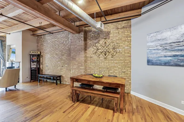 a view of a patio with table and chairs with wooden floor and fence
