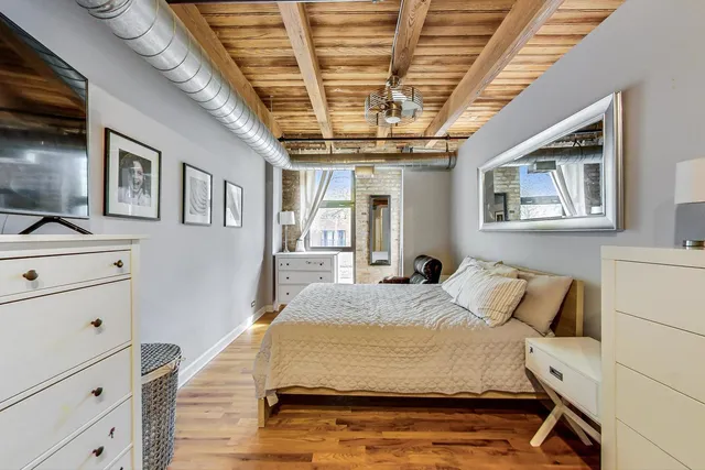 a bedroom with a large bed and a chandelier