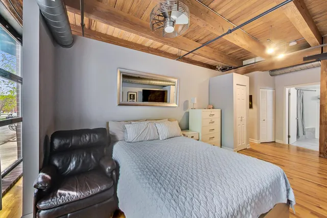 a bedroom with a bed couch and a window