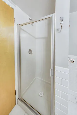 a bathroom with a glass shower door