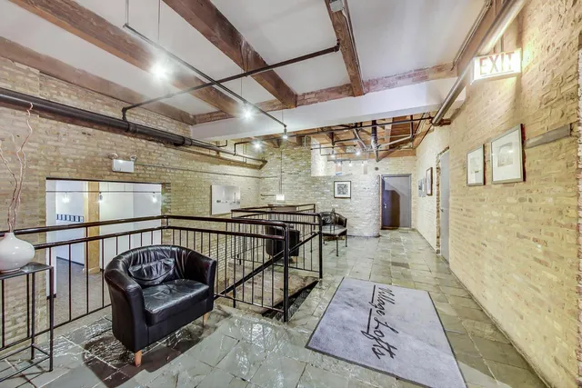 a view of a balcony with a couch and wooden floor