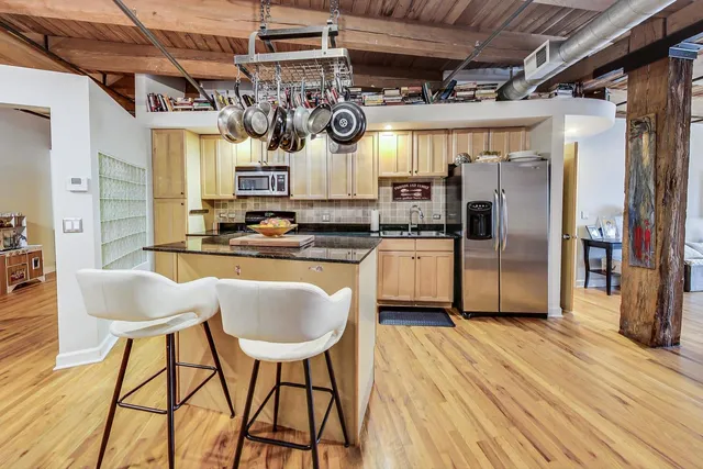 a kitchen with stainless steel appliances granite countertop a sink and cabinets