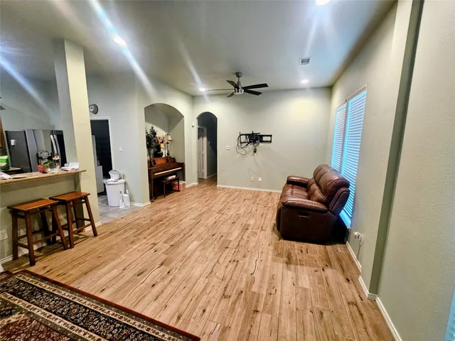 a living room with furniture and a wooden floor