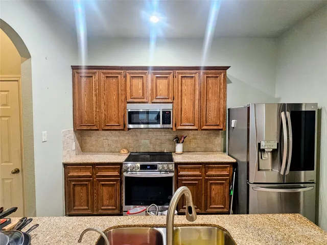 a kitchen with a refrigerator stove and sink