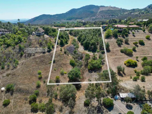 an aerial view of residential house and sandy dunes