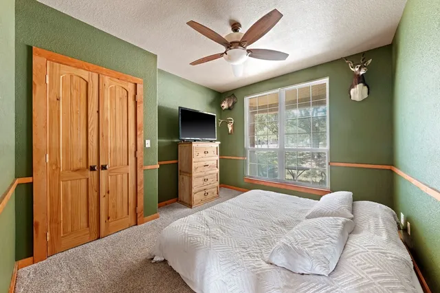 a bedroom with a bed and a large window