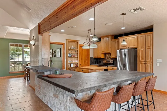 a dining table with chairs and window