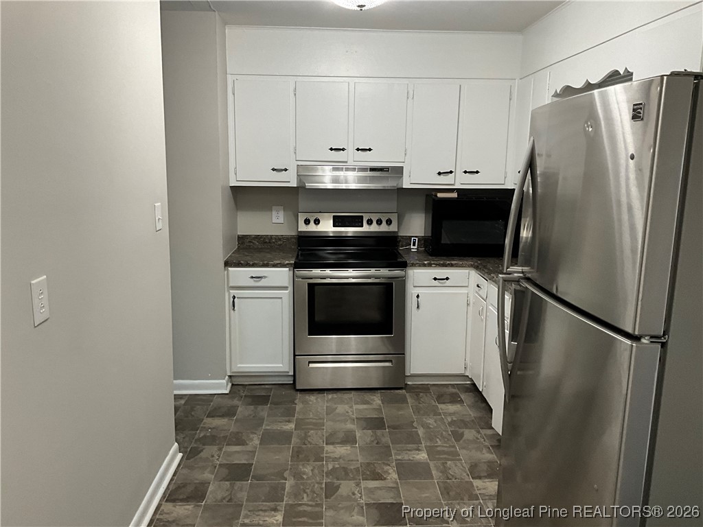 2238 Hope Mills Road Fayetteville, NC 28304 - Photo 3 of 9 a kitchen with a stove a refrigerator and a sink