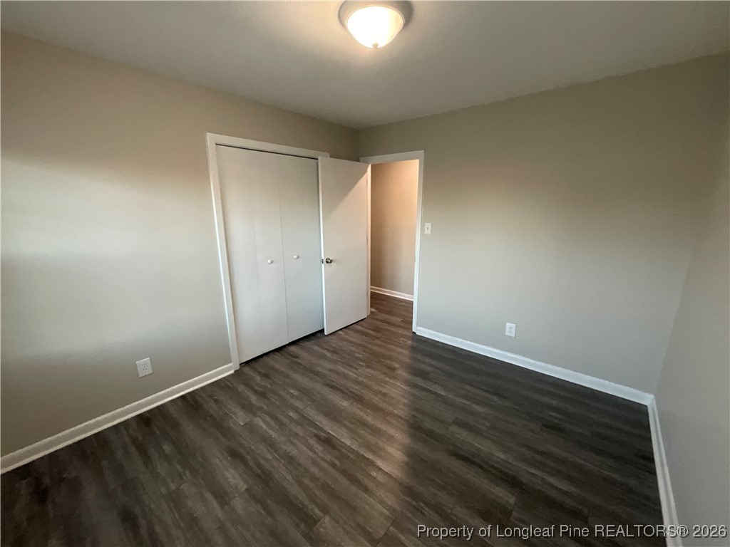 2238 Hope Mills Road Fayetteville, NC 28304 - Photo 4 of 9 a view of an empty room and wooden floor