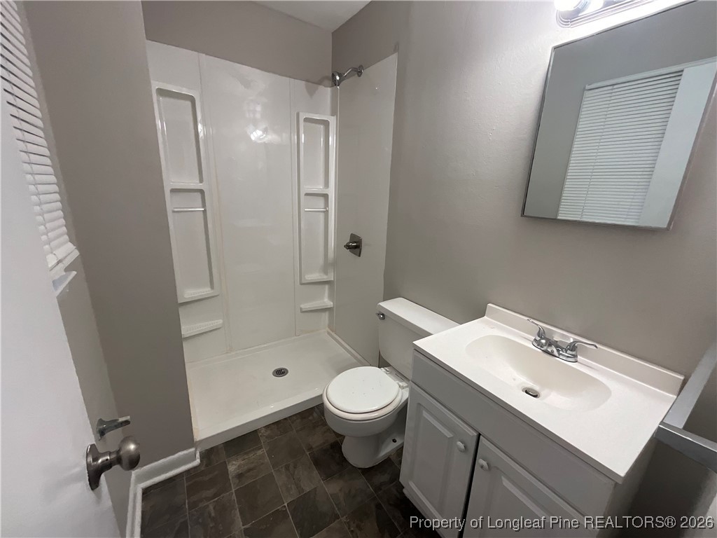 2238 Hope Mills Road Fayetteville, NC 28304 - Photo 5 of 9 a bathroom with a sink a toilet and shower