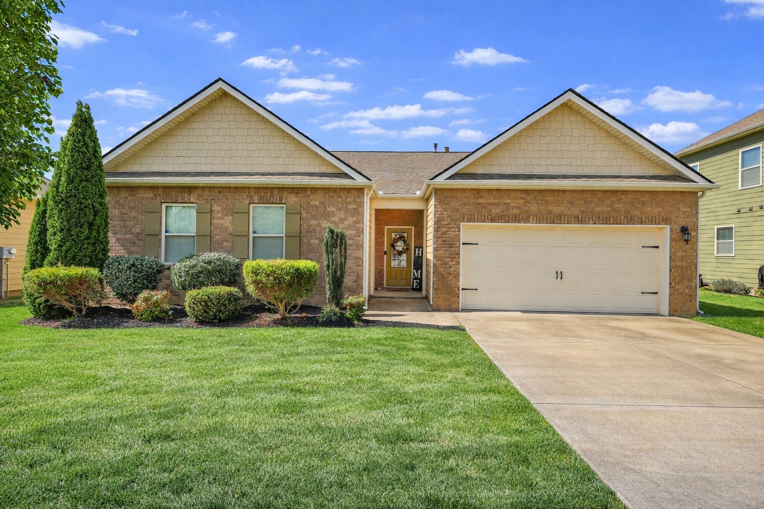 a view of a house with a yard and garage