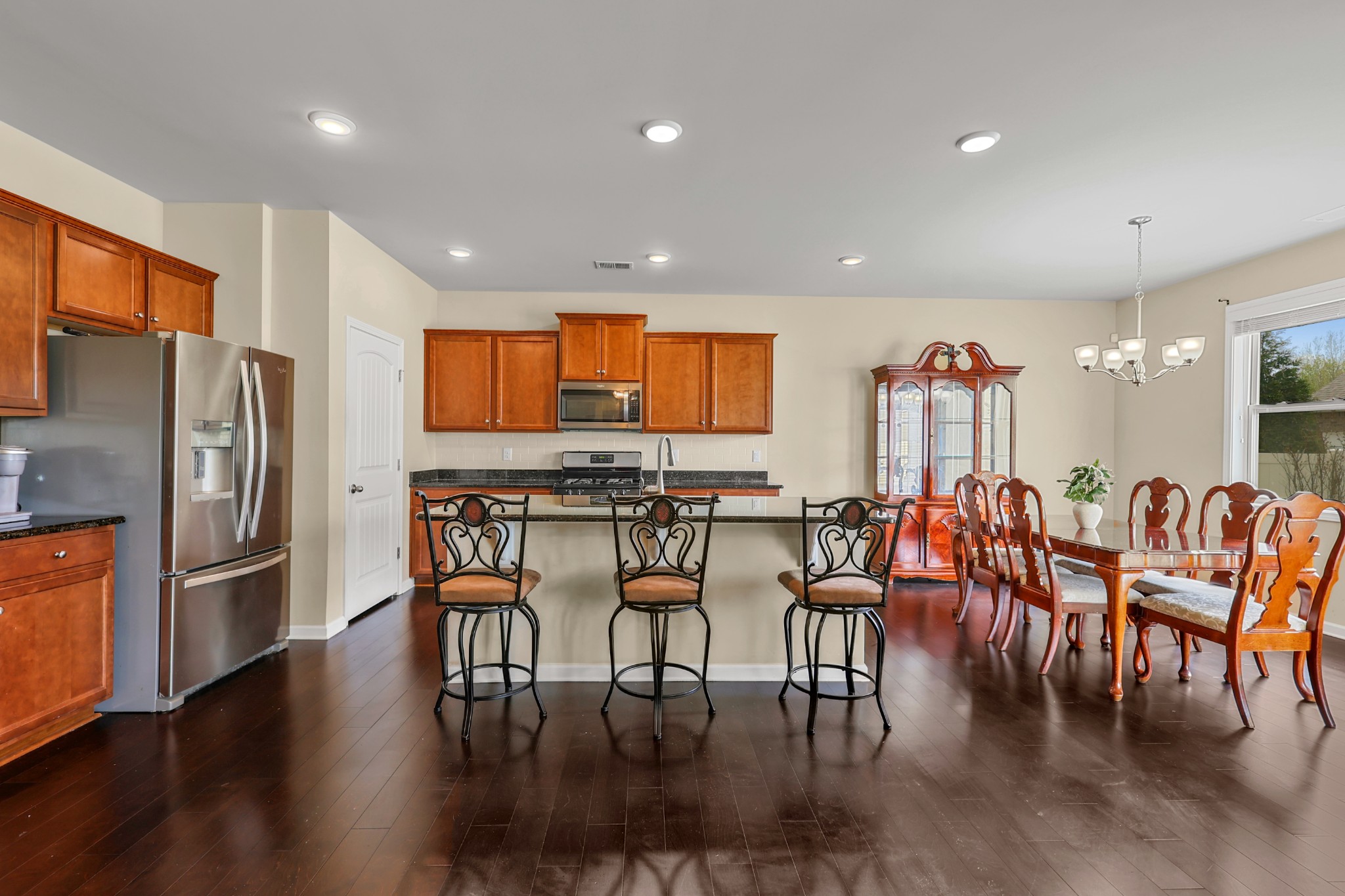 6515 Tulip Tree Drive Murfreesboro, TN 37128 - Photo 6 of 21 a kitchen with stainless steel appliances a dining table chairs and wooden floor
