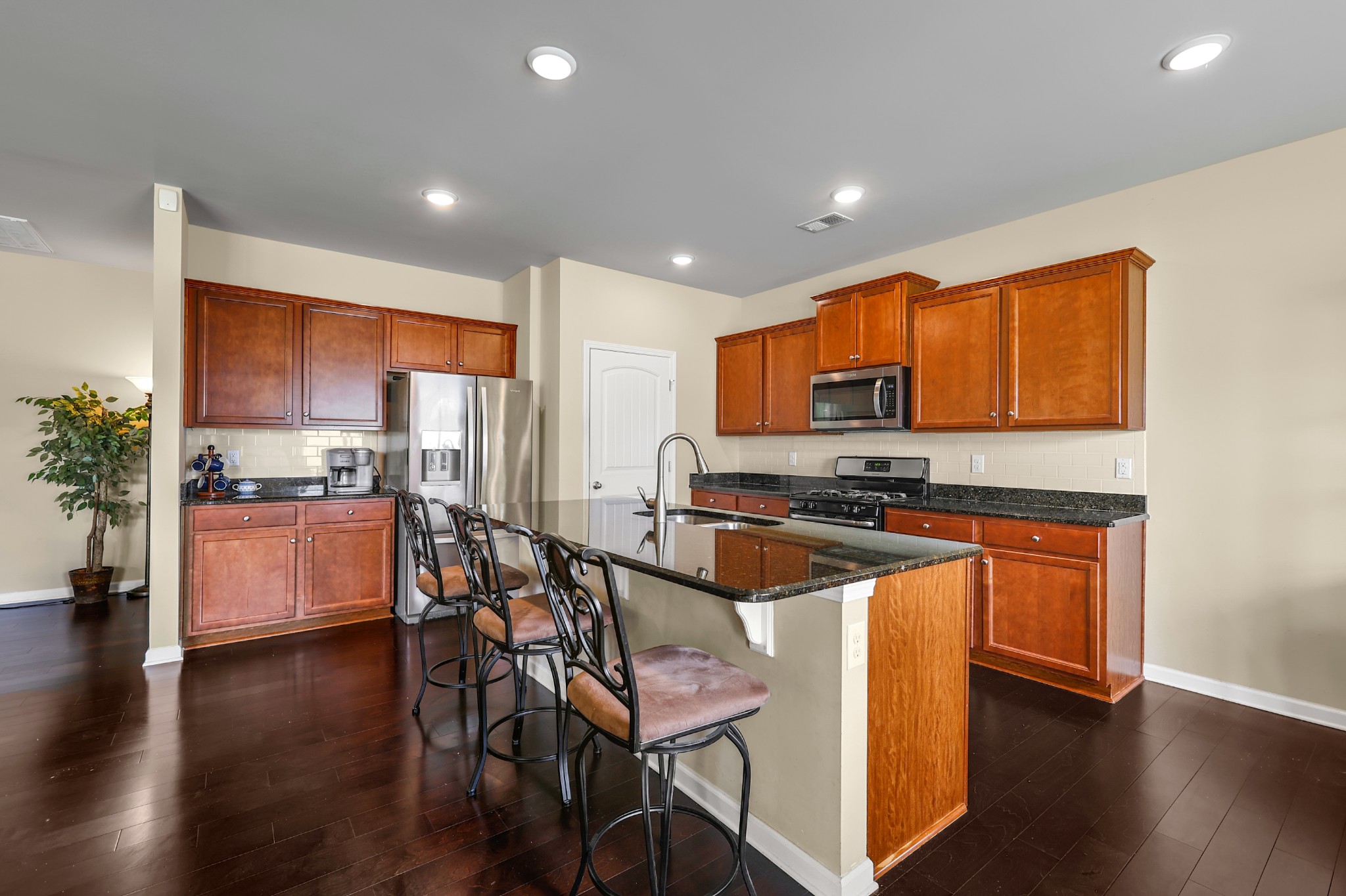 6515 Tulip Tree Drive Murfreesboro, TN 37128 - Photo 7 of 21 a kitchen with stainless steel appliances granite countertop wooden cabinets a refrigerator a stove a sink and a chairs